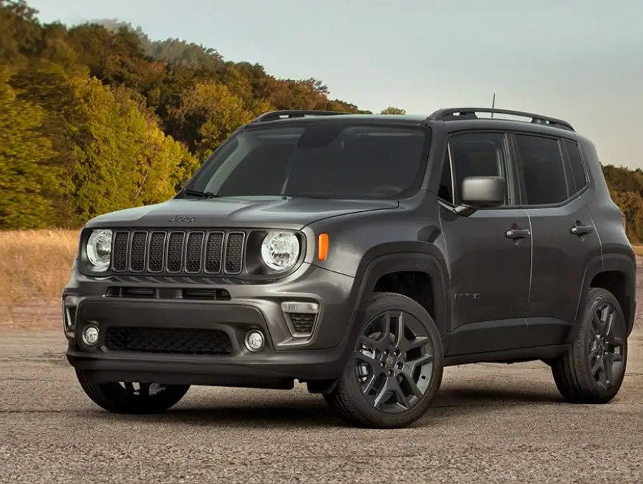 Dark grey 2022 Jeep Renegade on dirt road near forest