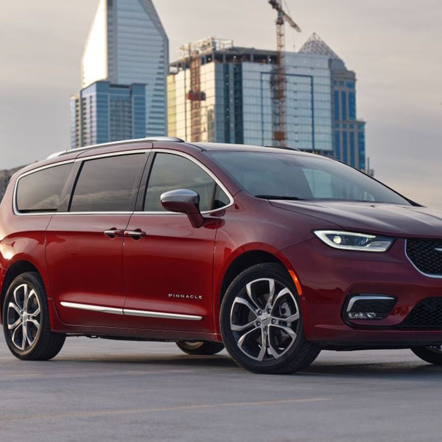 2022 burgundy Chrysler Pacifica minivan near buildings