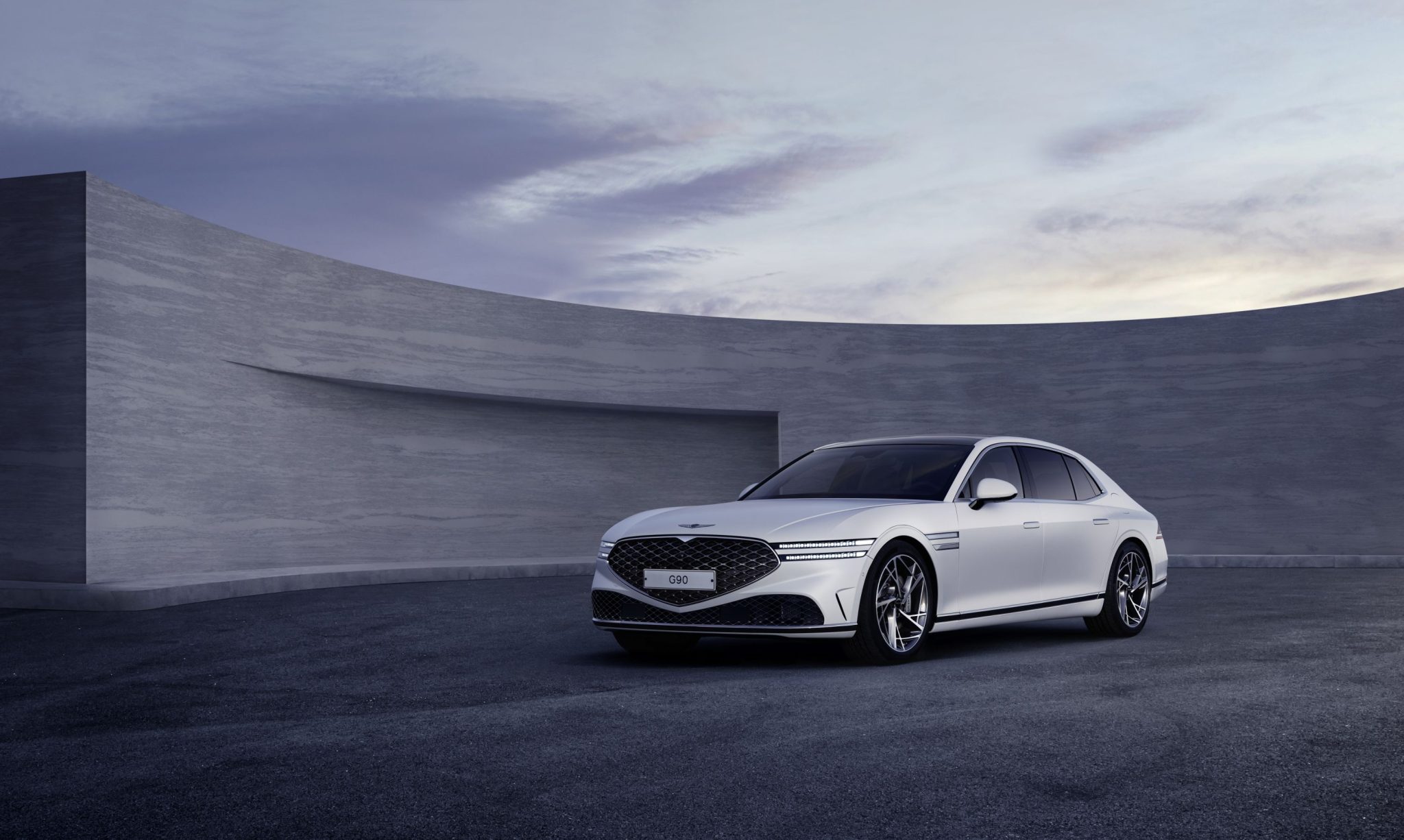 Three-quarter front view of a 2023 white Genesis G90