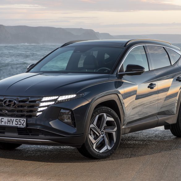 Three-quarter front view of a 2023 blue Hyundai Tucson Hybrid