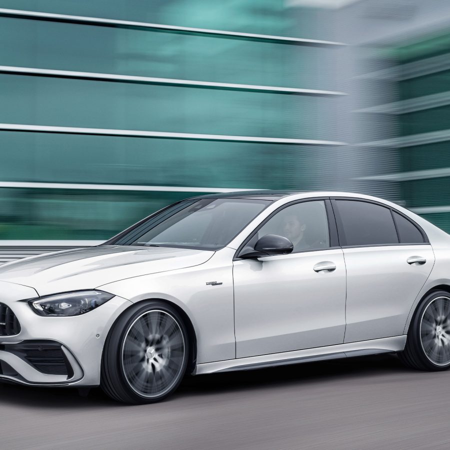 Three-quarter side view of a 2023 white Meredes AMG C43 4Matic