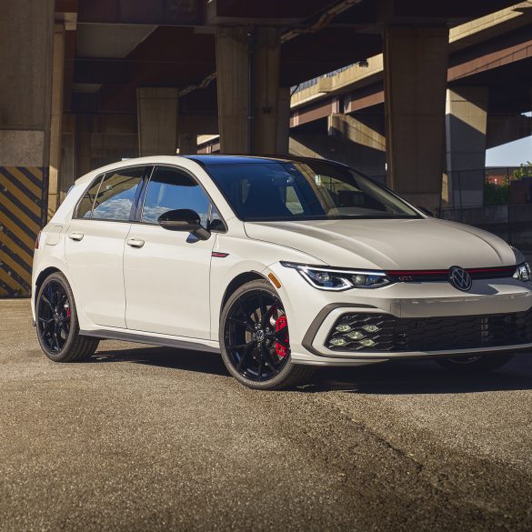 Three-quarter front view of a 2023 white Volkswagen Golf GTI