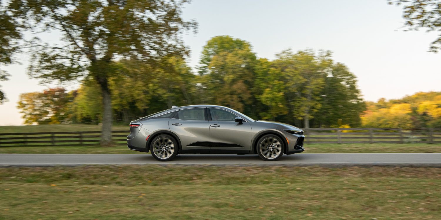 Side view of a 2024 silver Toyota Crown on a city street