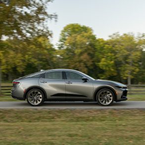 Side view of a 2024 silver Toyota Crown on a city street