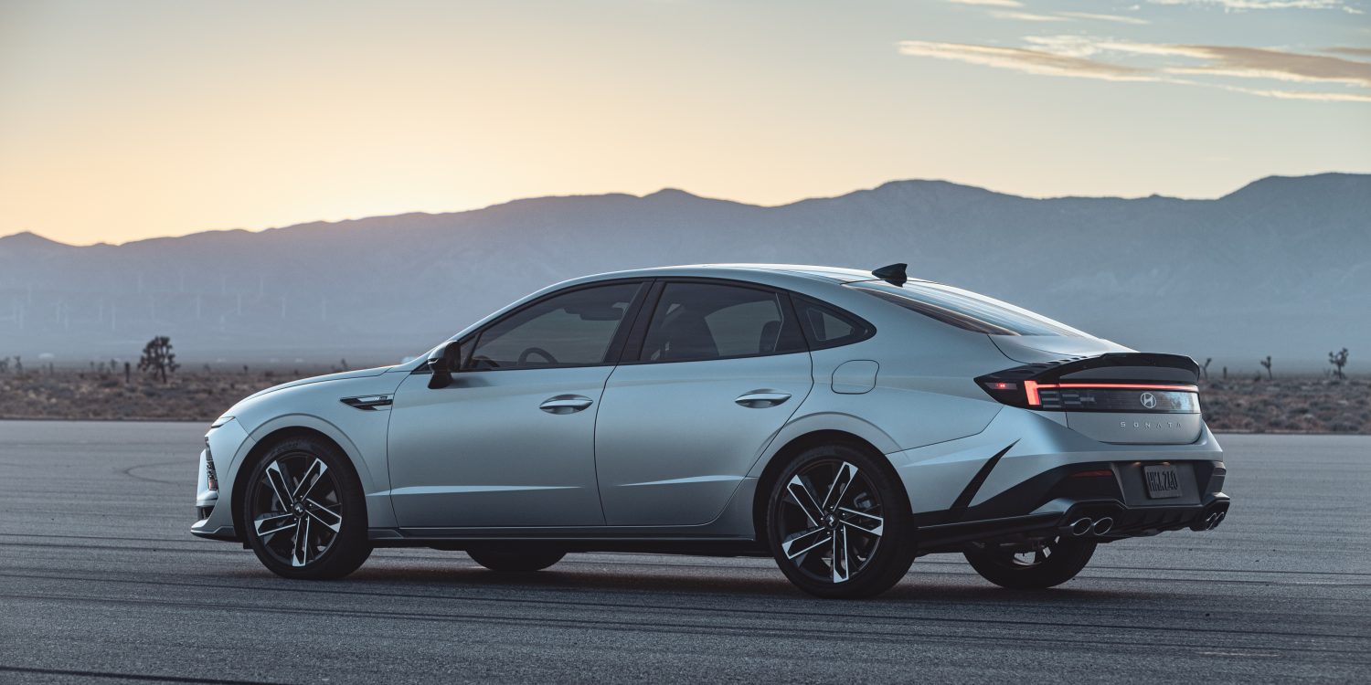 Three-quarter side view of a 2024 Hyundai Sonata N Line with mountain background