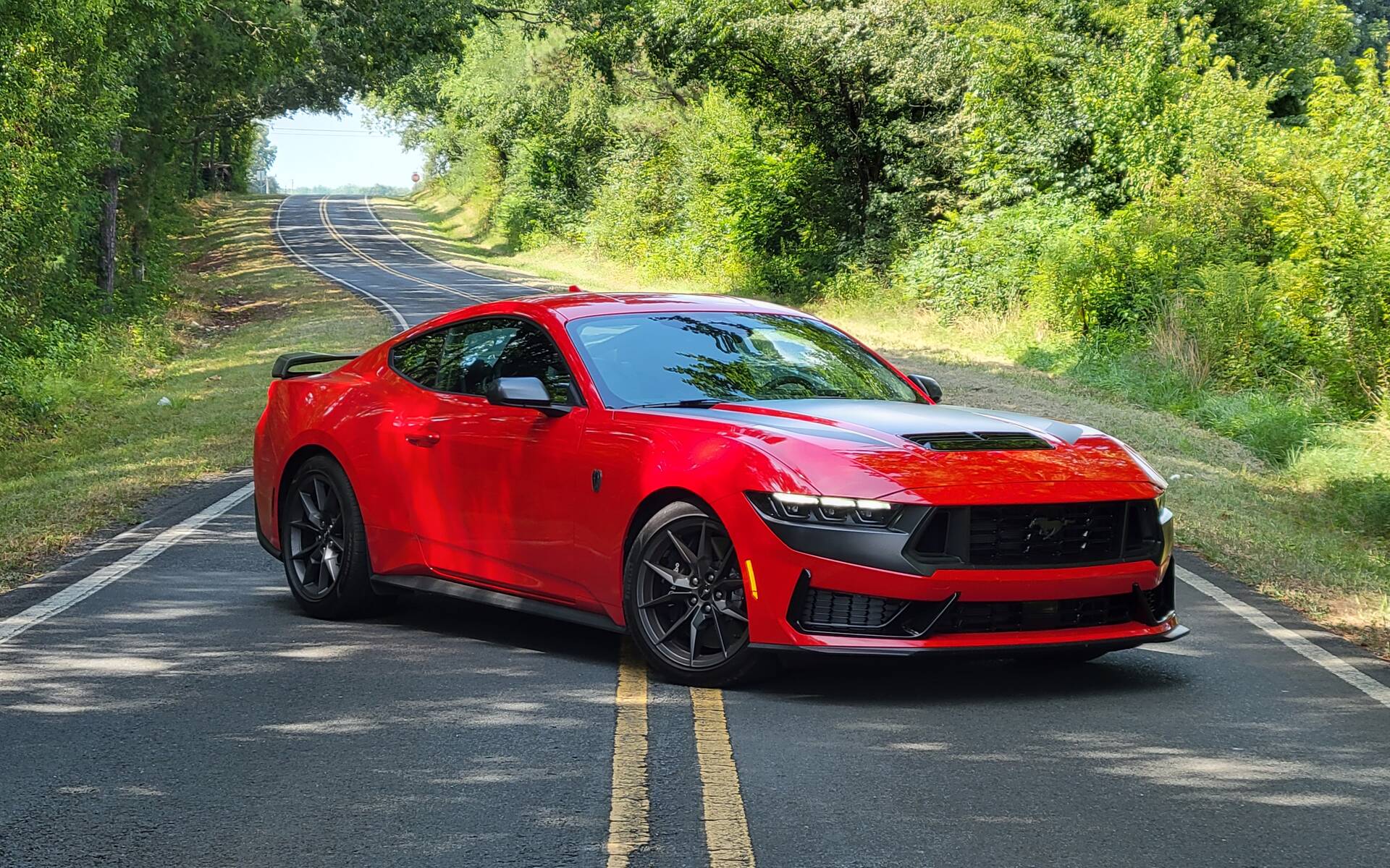 Front-angled view of a red Ford Mustang Dark Horse with black accents