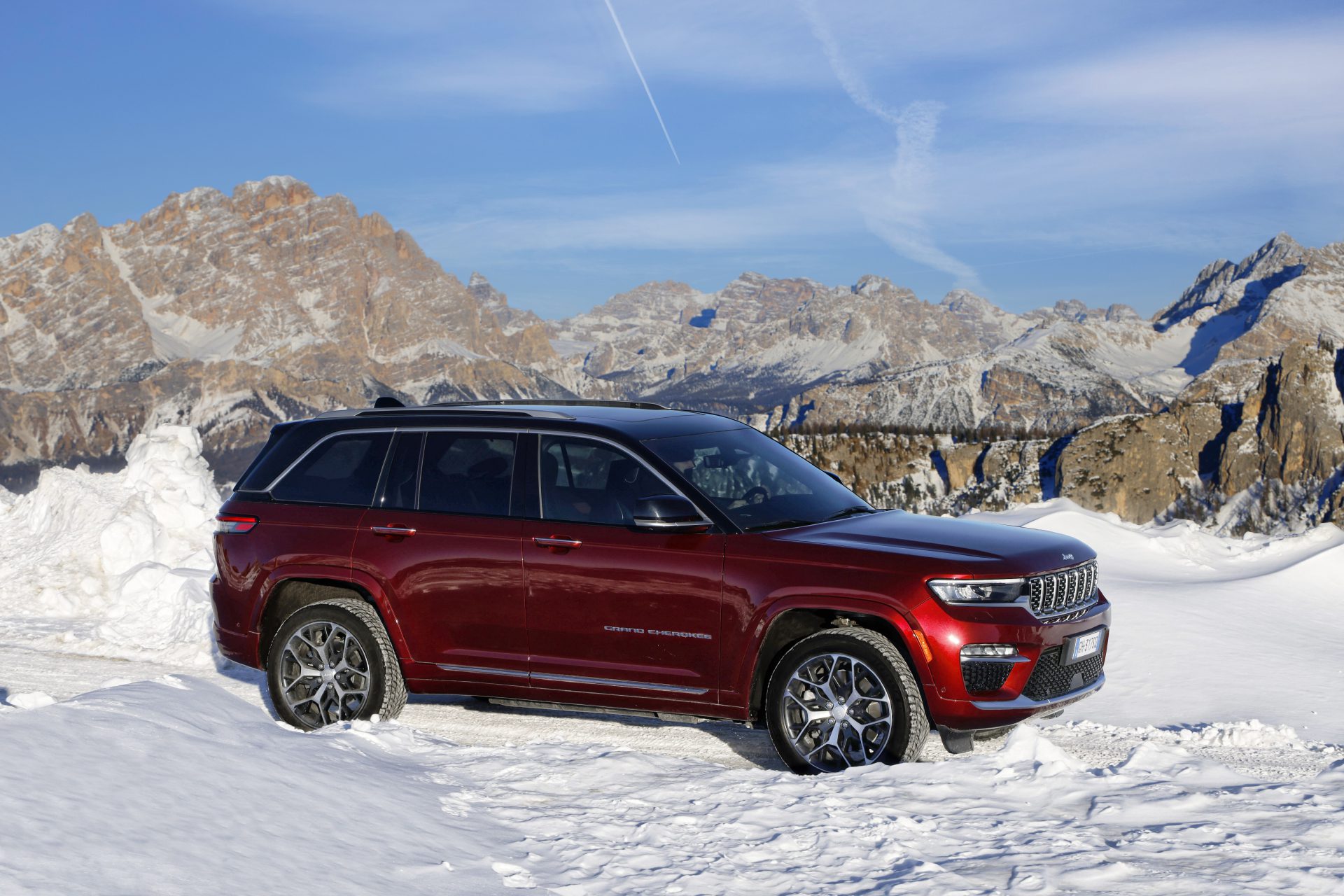 Side view of a 2024 velvet red Jeep Grand Cherokee 4xe