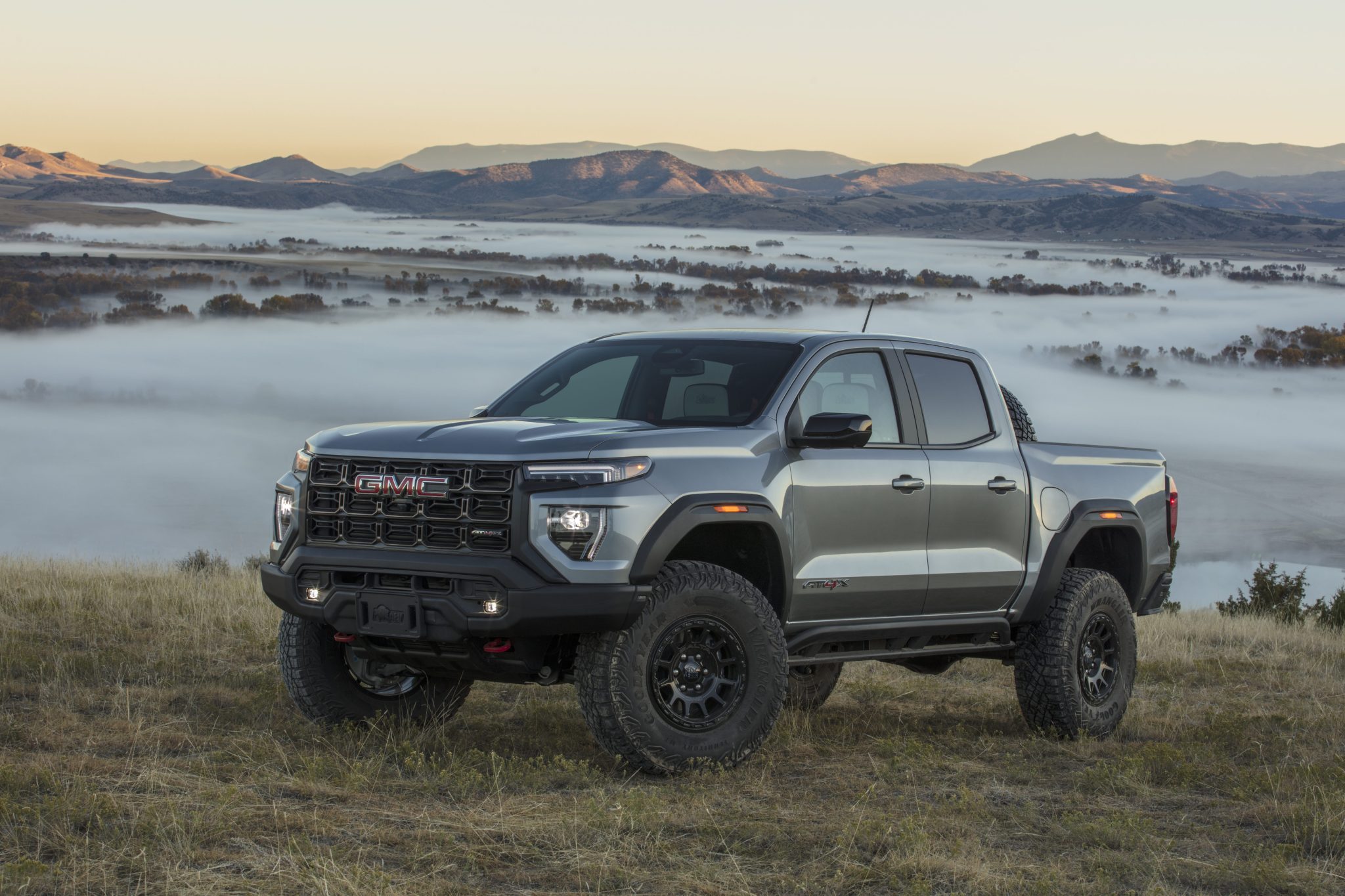 Front 3/4 view of the 2024 GMC Canyon AT4X AEV Edition in a field.