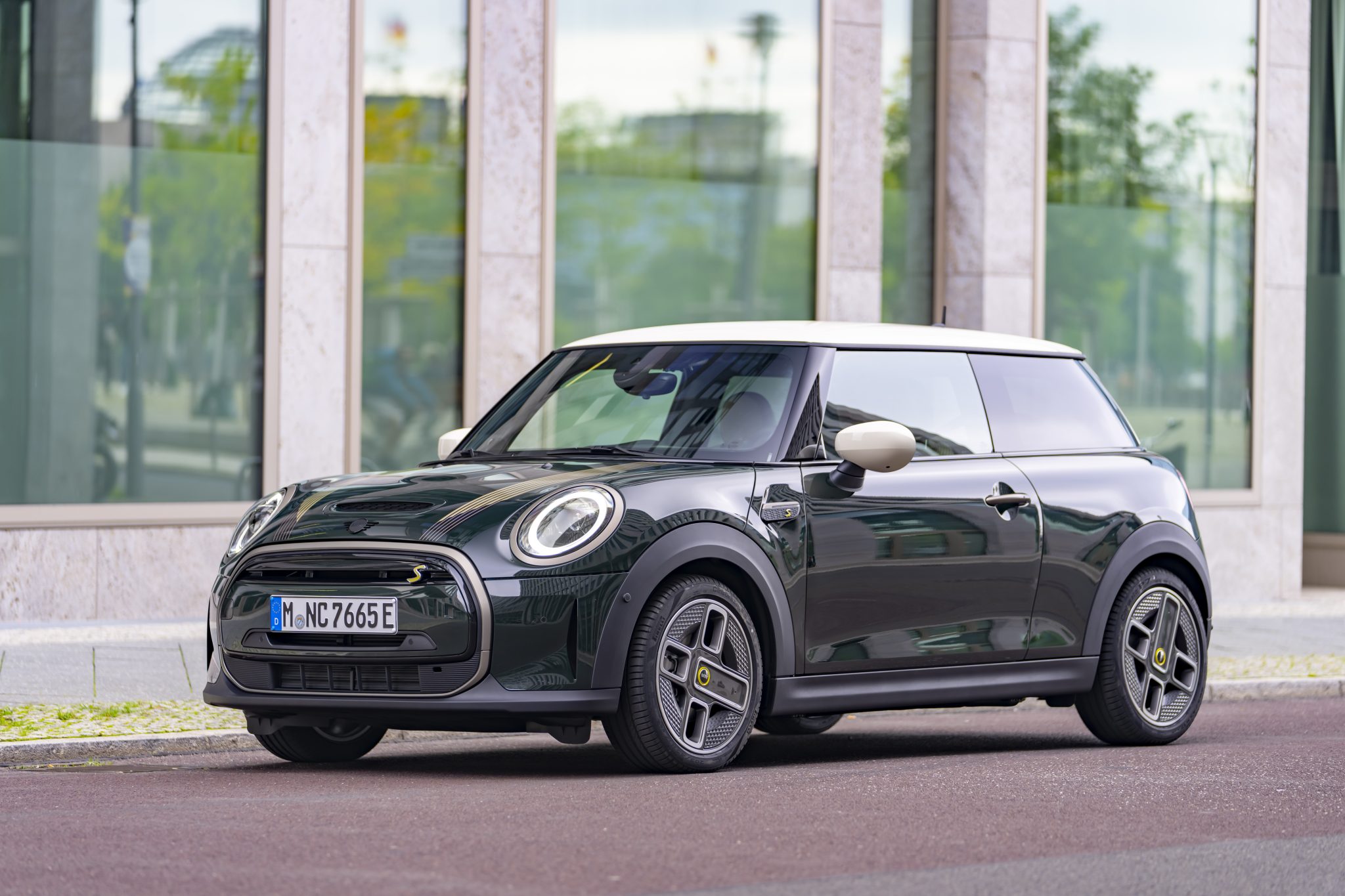 3/4 side view of a 2024 black Mini 2 door hardtop on a city street