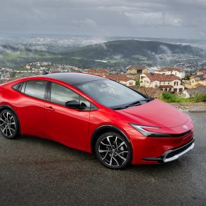 3/4 side view of a 2024 red Toyota Prius Prime