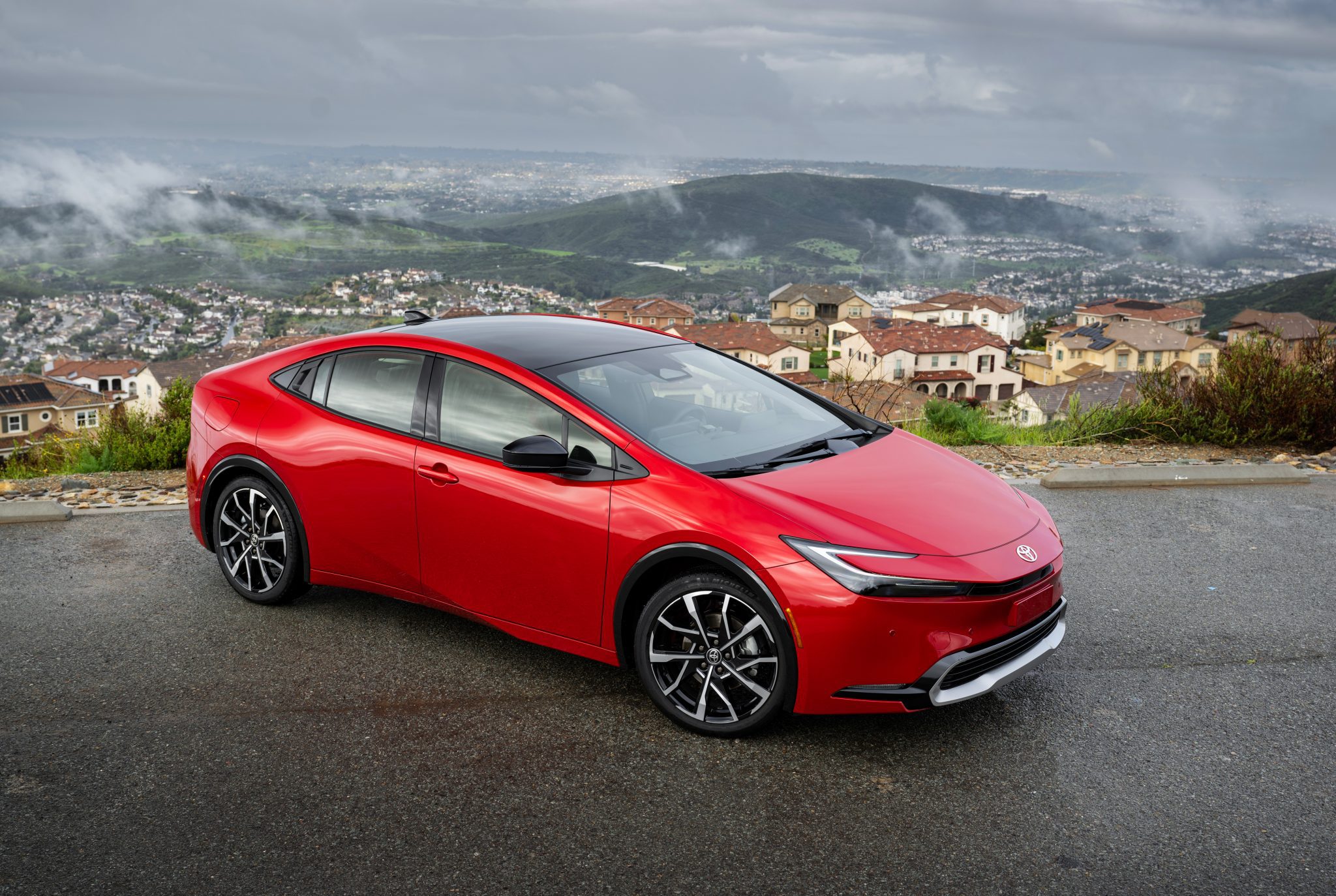 3/4 side view of a 2024 red Toyota Prius Prime