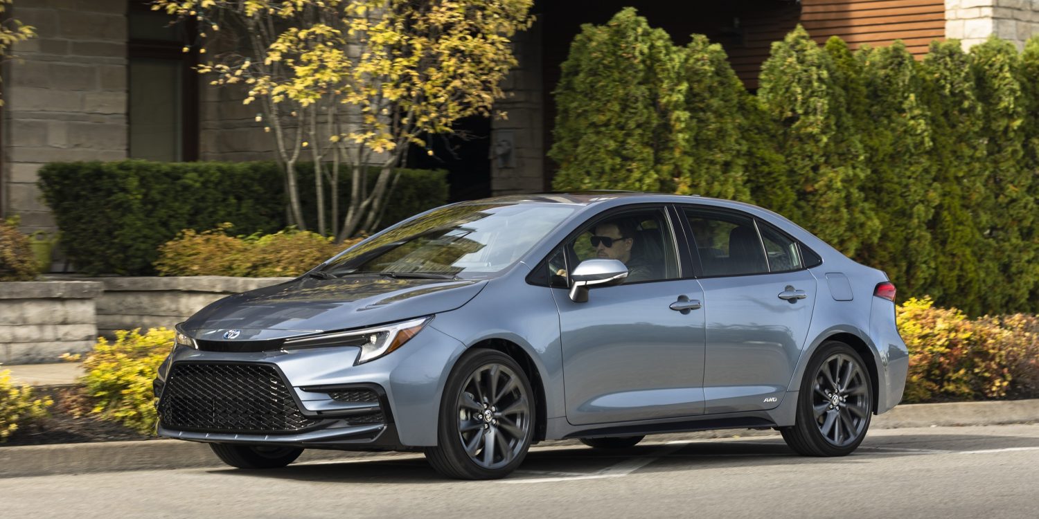 Three-quarter side view of a 2024 silver Toyota Corolla hybrid