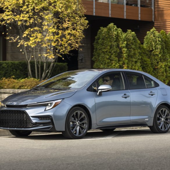 Three-quarter side view of a 2024 silver Toyota Corolla hybrid