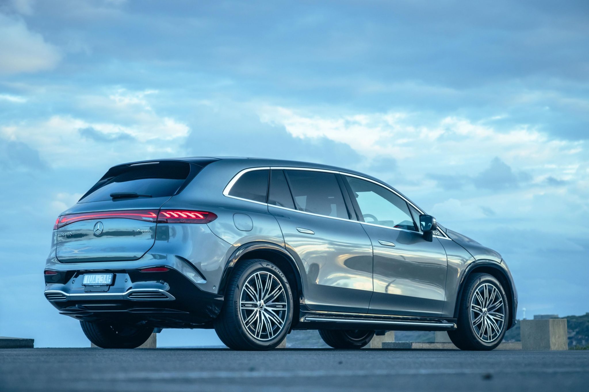 Rear-angled view of a blue Mercedes-Benz EQS SUV