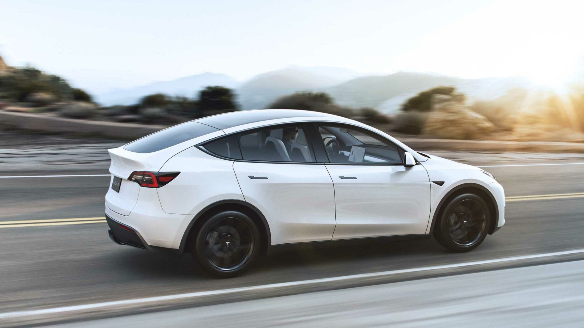 Rolling shot of a white Tesla Model Y